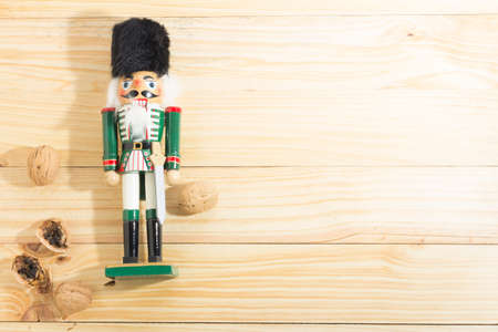 Xmas nutcracker soldier and nuts on wooden tableの写真素材