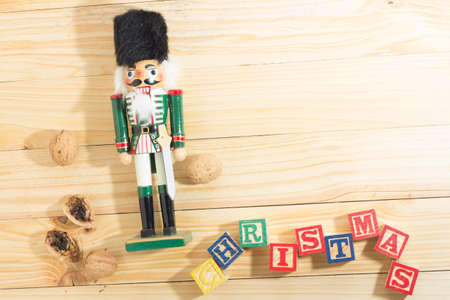 Xmas nutcracker soldier and nuts on wooden tableの写真素材
