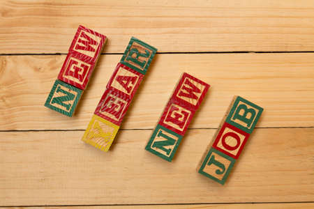 Wood cubes on wooden table with words New Year new job