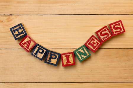 hapiness wood cube words on wooden tableの写真素材