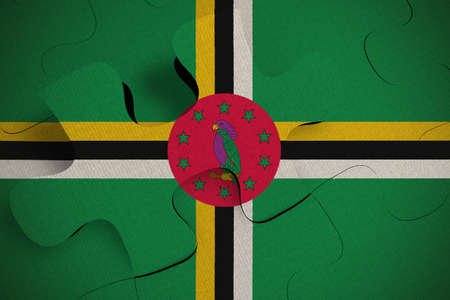 Composition of the concept of crisis and integration of a country Dominica FLAG PAINTED ON PUZZLE 3D RENDERの写真素材
