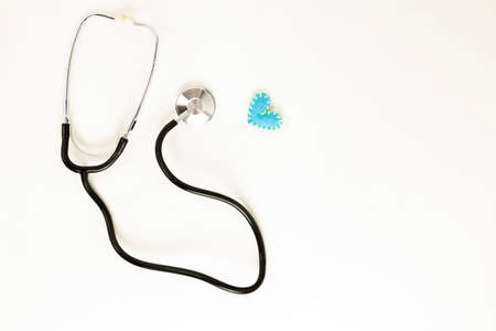 Heart health and prevention concept. Stethoscope and red heart of crochet on white isolated...