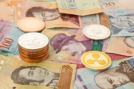 Several cryptocurrencies,bitcoin,ethereum,litecoin,ripple, accompanied by money from Venezuela.の写真素材