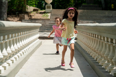 Caracas,Venezuela.Two little girls running in El Calvario Park, Ezequiel Zamora Park.のeditorial素材