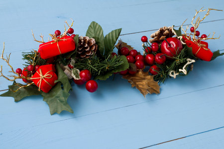 Interesting beautiful Christmas ornament decorations on blue colored wooden surface texture with copy space.の写真素材