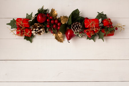 Interesting beautiful Christmas ornament decorations on white colored wooden surface texture with copy space.の写真素材