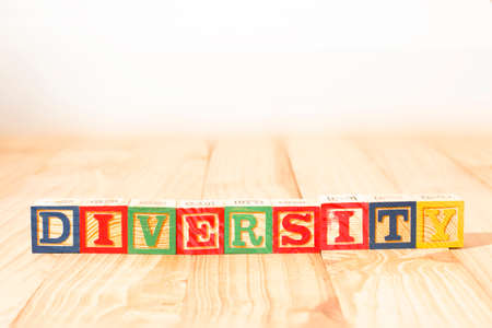 Spectacular wooden cubes with the word DIVERSITY on a wooden surface.の写真素材