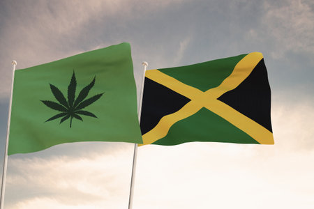 Interesting Flags of JAMAICA and that of the legalization of marijuana waving with the bright sky in the background.の写真素材
