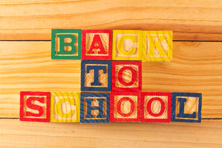 Spectacular representation of back to school with wooden cubes on a wooden board.の写真素材