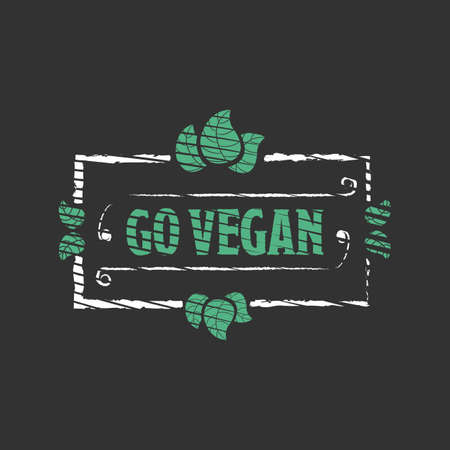 Go vegan Organic food engraved icon with leafs on black backgroundの写真素材