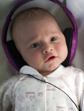 baby with lilac headphones close-up