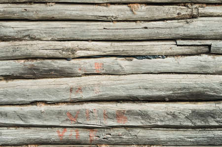 Old log house with red paintの写真素材