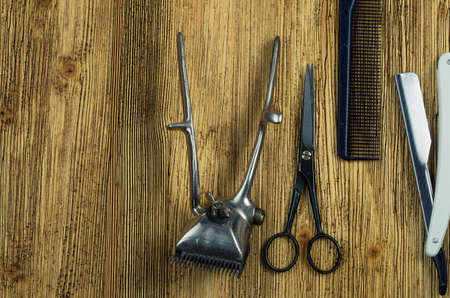 vintage hairdressing tools on a rough wooden surface free space on the left.の写真素材