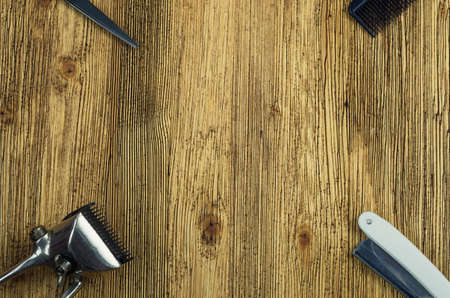 Vintage hairdressing tools on a rough wooden surface free in the center.の写真素材