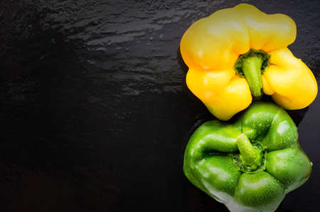 two sweet pepper on slate yin yang place on the left. top viewの写真素材