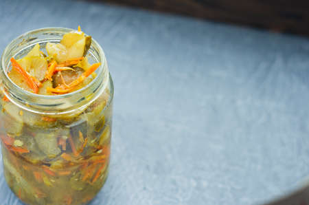 pickled fermented cucumbers and carrots in a jar.