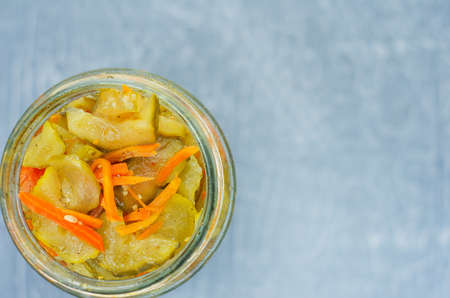 pickled fermented cucumbers and carrots in a jar. Top vew.の写真素材