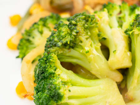 cooked vegetables broccoli, carrots, green beans, corn on a white plate. closeupの写真素材
