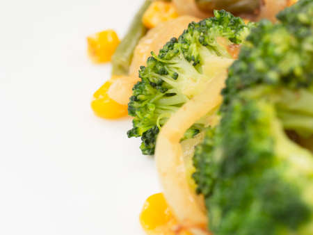cooked vegetables broccoli, carrots, green beans, corn on a white plate. closeupの写真素材