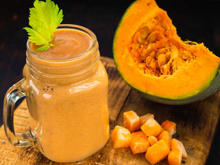 Pumpkin smoothie with celery leaves and pumpkin cubes.の写真素材