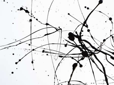 Dripping black paint isolated on white background. Flowing fuel oil splashes, drops and trail.の写真素材