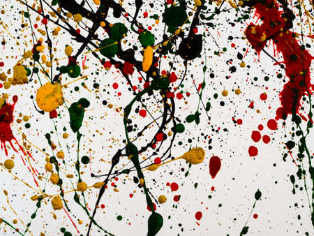 an abstraction with splashes of black and red and green and yellow paint on a white background