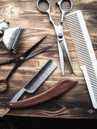 vintage and new barber shop tools on wood background. vertical