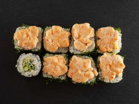 sushi rolls on gray stone slate on wood background. made by handの写真素材