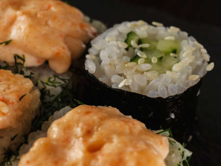 sushi rolls on gray stone slate on wood background. made by handの写真素材