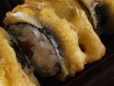 sushi rolls on gray stone slate on wood background. made by handの写真素材
