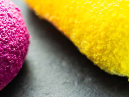 yellow and purple cake on slate. Shallow depth of field.