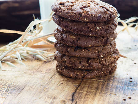oatmeal cookies oats and milk on a wooden background.