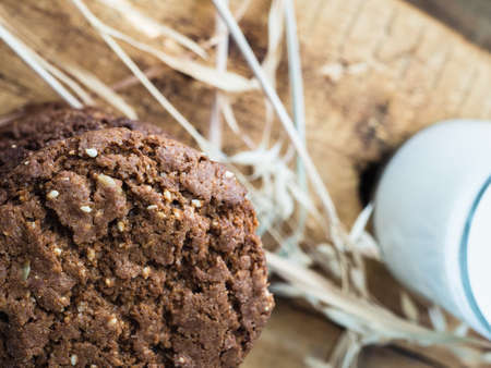 oatmeal cookies oats and milk on a wooden background.