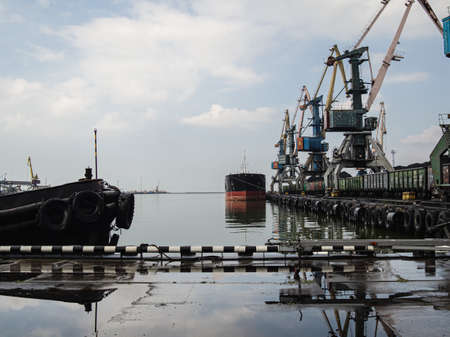 unloading of a tanker and loading into a freight train at a port of coal using powerful and large...