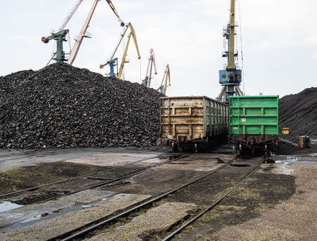 loading unloading of coal in the port into freight trains using large port cranes.の写真素材