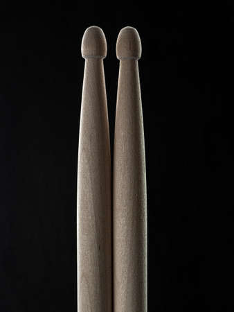 Used drumsticks isolated on black background.