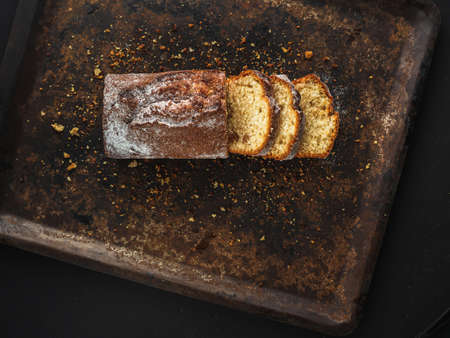 Rectangular loaf cut into pieces with a white sprinkle is on a rusty protvin. Which is oriented at an angle. Horizontal orientationの写真素材