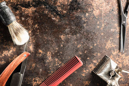 barber tools hairdressing scissors vintage manual clipper comb brush dangerous razor are on a on a rusty old beautiful surface. copy space. Horizontal orientation. flat lay. top viewの写真素材