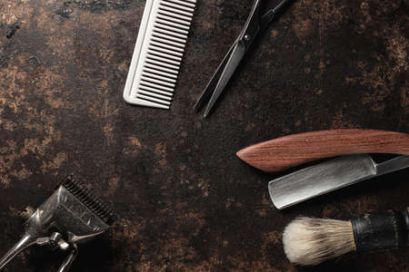 vintage barber tools dangerous razor hairdressing scissors old manual clipper comb shaving brush. old rusty metal background.の写真素材