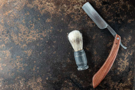 vintage barber tools dangerous razor hairdressing scissors old manual clipper comb shaving brush. Beautiful rusty metal background. top view flat lay. Horizontal. copy spaceの写真素材