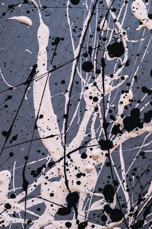 Abstract expressionism. Picture painted using the technique of dripping. Mixing different colors white and black. Lines and spots. Vertical orientation.の写真素材
