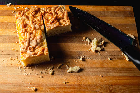 cut pie on a cutting board. three square pieces of four. lies on a striped old cutting board. A lot...