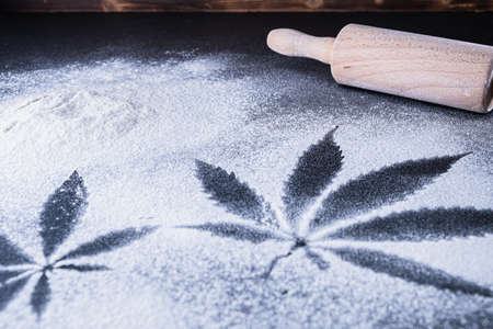 The process of making cannabis pastries. You can see a rolling pin and tiles hashish oil. Horizontal orientationの写真素材