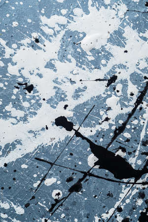 background graphic image. dripping. expression. multicolored color spill blemish. mixing colors. black and white . On the concrete texture. Vertical orientation. top view. flat lay.の写真素材