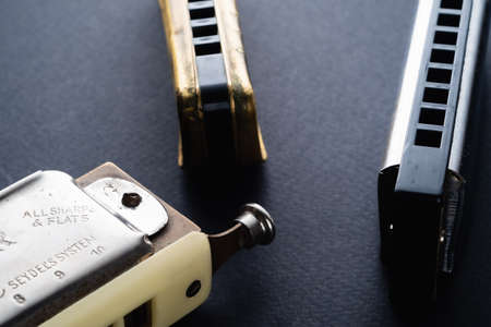 musical instruments old diatonic and chromatic labial are next to a dark background. Horizontal orientation.の写真素材