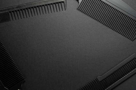 On a black surface are old barber tools. barber tools. four comb. black monochrome. frame. top view flate lay. frame copy spaceの写真素材