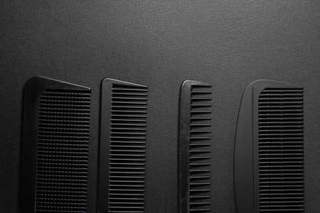 On a black surface are old barber tools. barber tools. four comb. black monochrome. frame. top view flate lay. copy spaceの写真素材