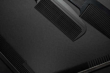 On a black surface are old barber tools. barber tools. four comb. black monochrome. frame. top view flate lay.の写真素材