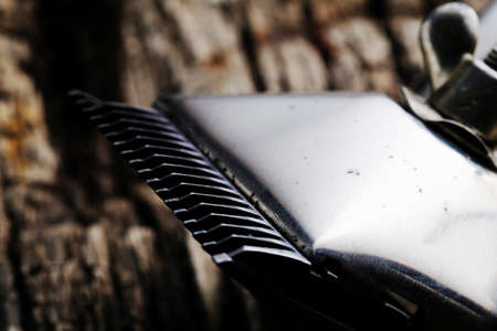 On a old wooden surface are old barber tools. Vintage manual hair clipper. horizontal orientation.の写真素材