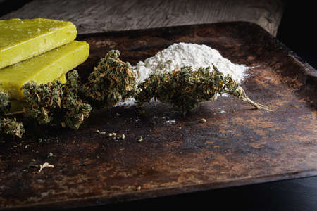rustic cannabis butter and medical marijuana bud and flour on old rust metal dripping pan. old wooden background. horizontal. close-up.の写真素材
